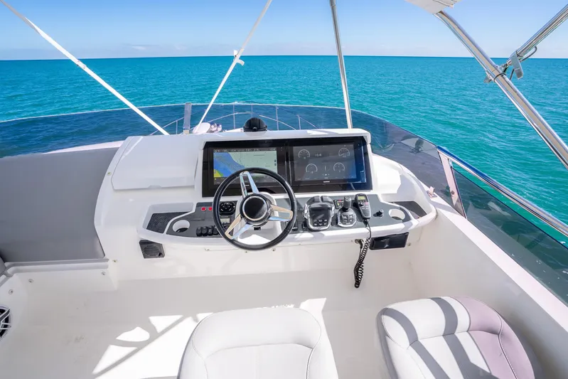Chill Yacht Photos Pics Helm of 2018 Princess F49 yacht with ocean view and modern navigation controls.