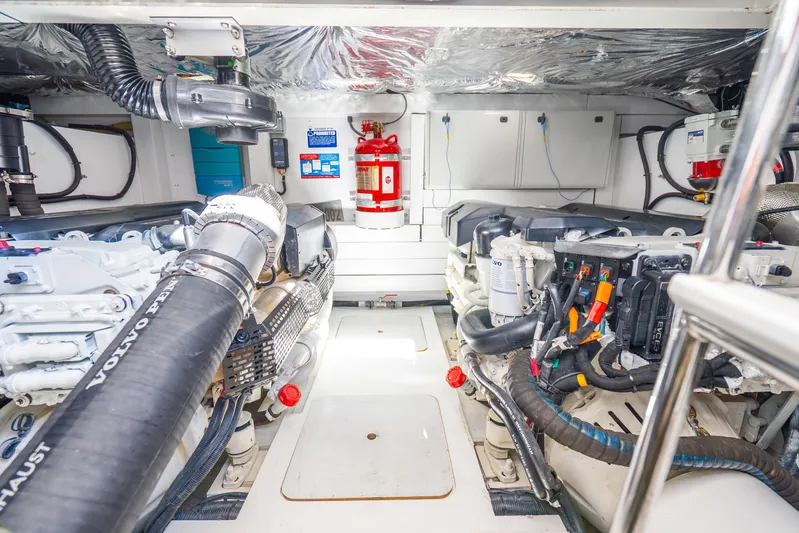 Chill Yacht Photos Pics Engine room of a 2018 Princess F49 yacht, featuring Volvo Penta components and fire safety equipment.