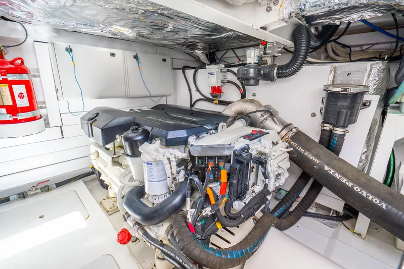 Chill Yacht Photos Pics Engine room of 2018 Princess F49 yacht with Volvo Penta engine and fire extinguisher.