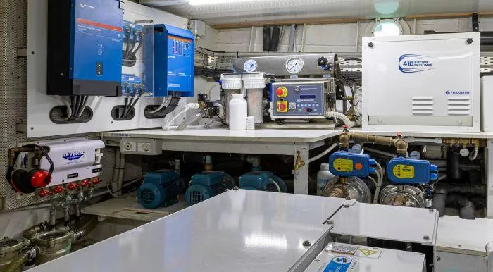 Sally Yacht Photos Pics Engine room of a 1959 Burger 60 yacht, featuring modern equipment and control panels.