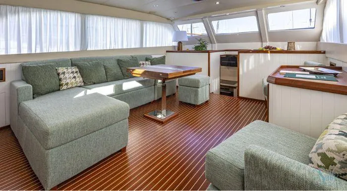 Sally Yacht Photos Pics Luxurious interior of a 1959 Burger 60 yacht with elegant wood flooring and plush seating.