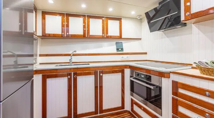 Sally Yacht Photos Pics Vintage 1959 Burger 60 yacht kitchen with wood accents and modern appliances.