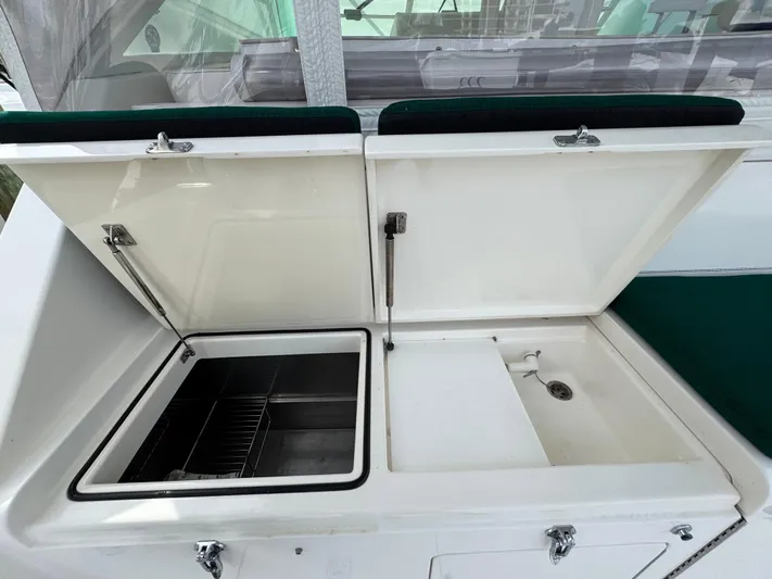  Yacht Photos Pics 1999 Cabo 45 Express boat sink and storage area with open lids.