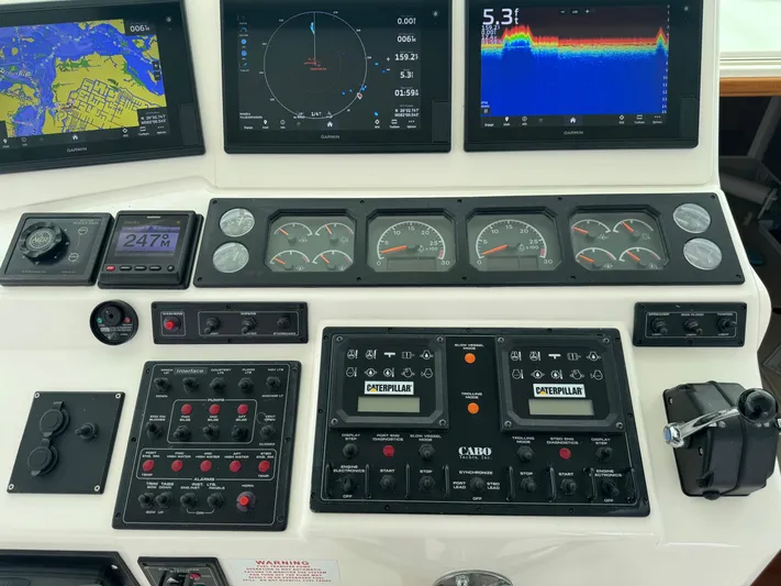  Yacht Photos Pics Control panel of a 1999 Cabo 45 Express boat with navigation and engine displays.