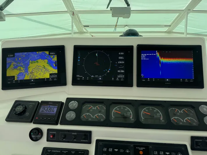  Yacht Photos Pics Dashboard of a 1999 Cabo 45 Express boat with navigation and sonar displays.