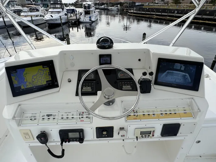  Yacht Photos Pics Helm of 1999 Cabo 45 Express boat with navigation screens and controls.