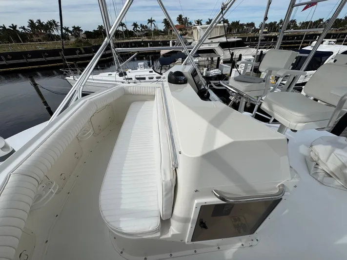  Yacht Photos Pics 1999 Cabo 45 Express yacht interior with white seating and helm, docked at marina.