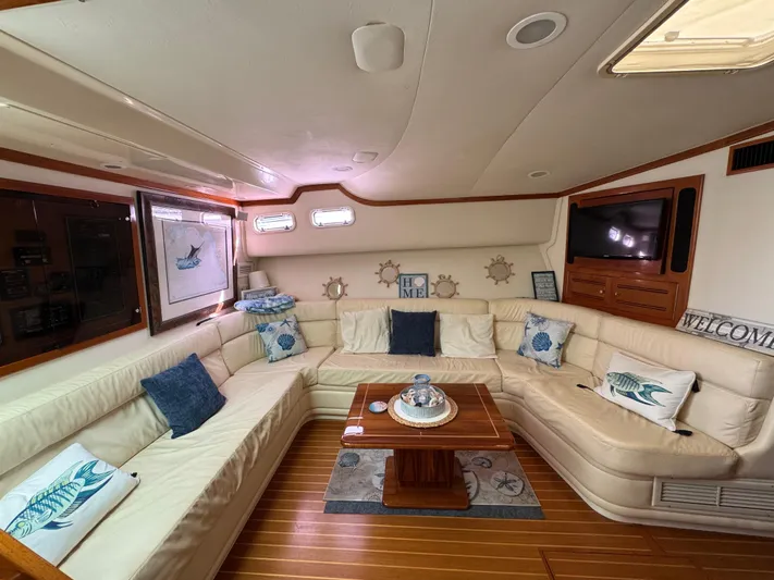  Yacht Photos Pics Luxurious interior of a 1999 Cabo 45 Express yacht with plush seating and nautical decor.