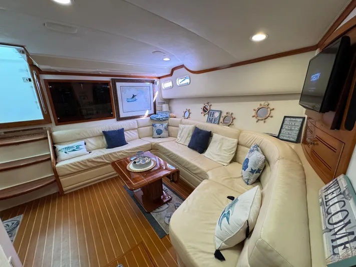  Yacht Photos Pics Luxurious interior of 1999 Cabo 45 Express yacht with plush seating and nautical decor.