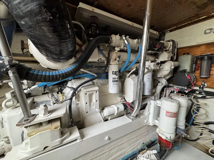  Yacht Photos Pics Engine room of 1999 Cabo 45 Express boat with CAT components and blue hoses.