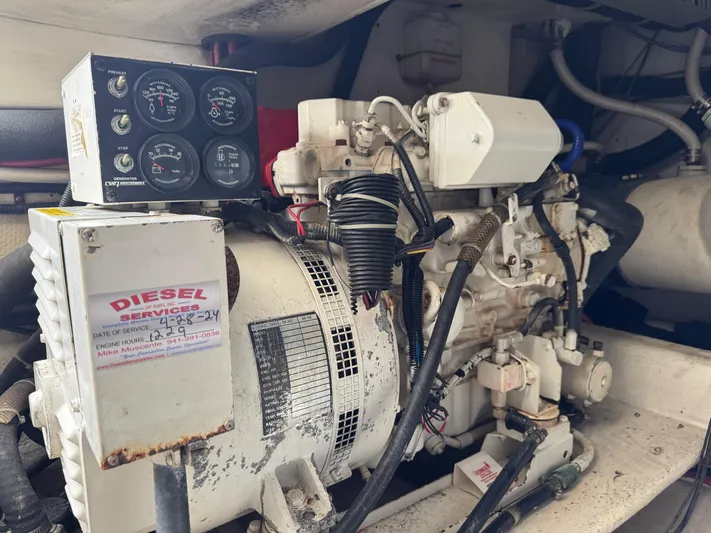  Yacht Photos Pics Diesel engine in a 1999 Cabo 45 Express boat, featuring control gauges and wiring.