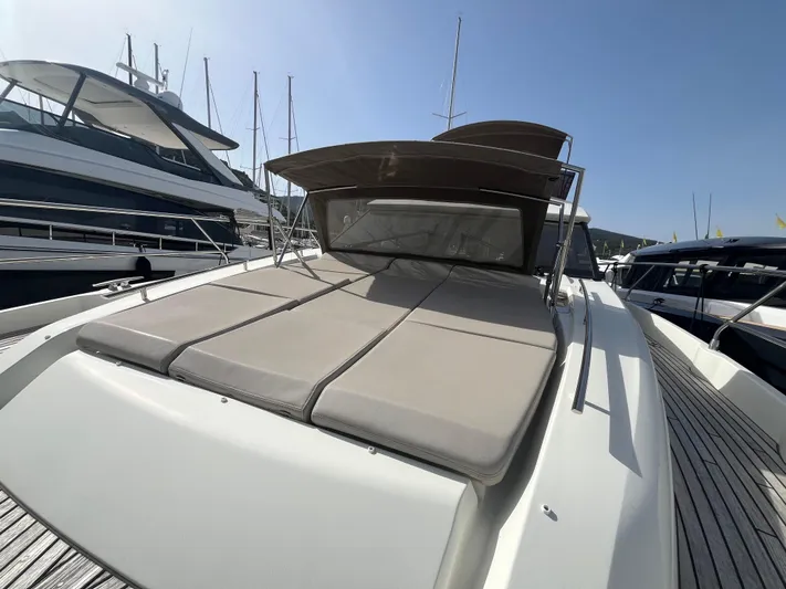  Yacht Photos Pics 2018 Prestige 520 yacht with sunbathing deck, docked in marina under clear sky.