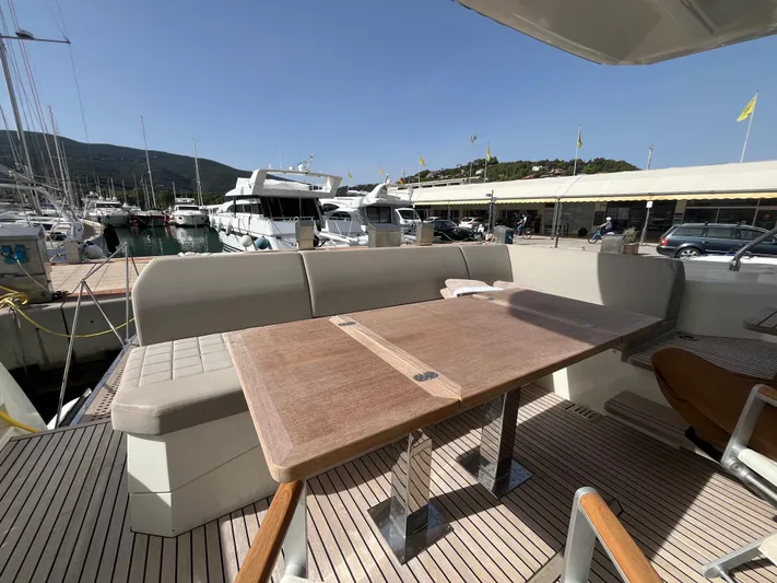  Yacht Photos Pics Outdoor seating area on a 2018 Prestige 520 yacht, docked at a marina.