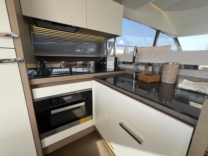  Yacht Photos Pics Modern kitchen interior of 2018 Prestige 520 yacht with sleek appliances and cabinetry.