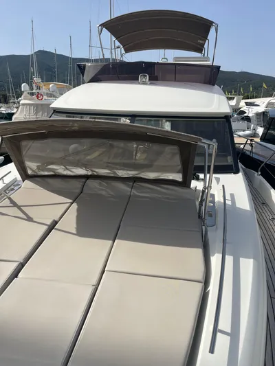  Yacht Photos Pics 2018 Prestige 520 yacht with sunbathing area, docked in a marina.
