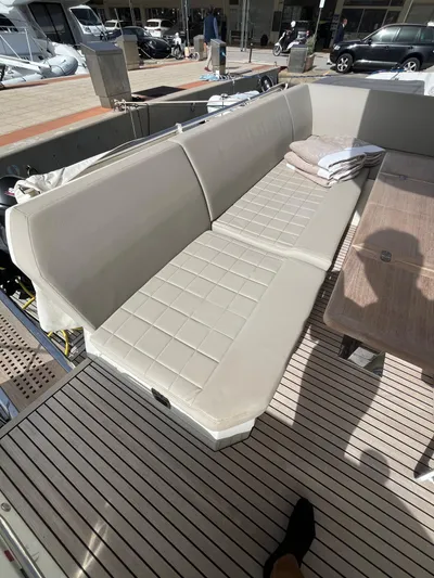  Yacht Photos Pics Luxurious seating on 2018 Prestige 520 yacht, featuring beige upholstery and wooden deck.