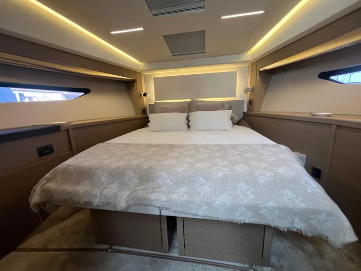  Yacht Photos Pics Luxurious bedroom interior of 2018 Prestige 520 yacht with elegant lighting and cozy bedding.