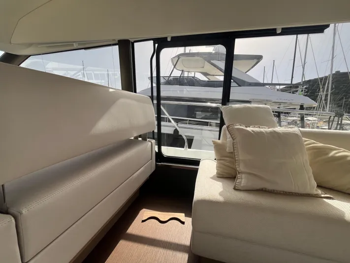  Yacht Photos Pics Luxurious interior of 2018 Prestige 520 yacht with plush seating and marina view.