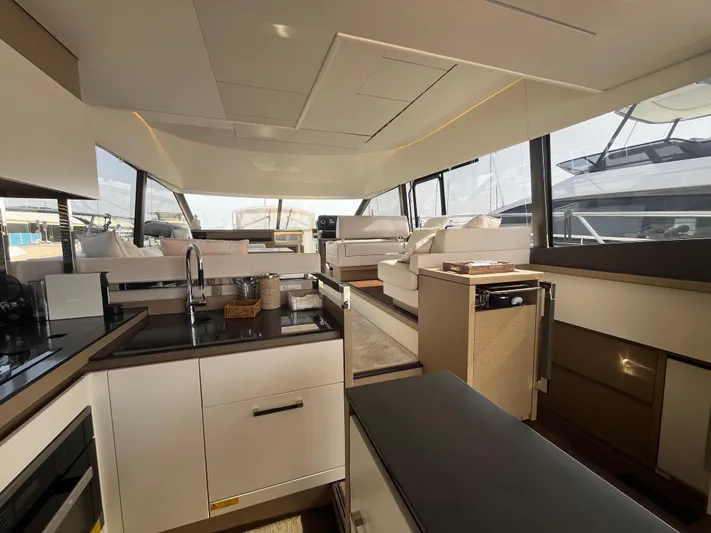  Yacht Photos Pics Luxurious interior of a 2018 Prestige 520 yacht with modern kitchen and seating area.