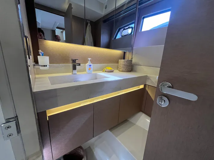  Yacht Photos Pics Luxurious bathroom interior of a 2018 Prestige 520 yacht, featuring modern fixtures and ambient lighting.