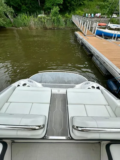  Yacht Photos Pics 2023 Regal 2800 Bowrider at dock, featuring spacious seating and sleek design.