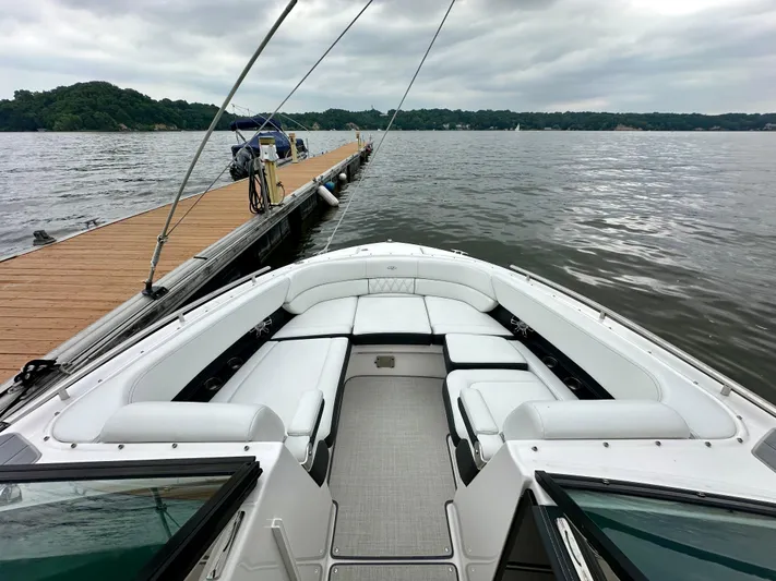  Yacht Photos Pics 2023 Regal 2800 Bowrider docked on a calm lake with overcast skies.