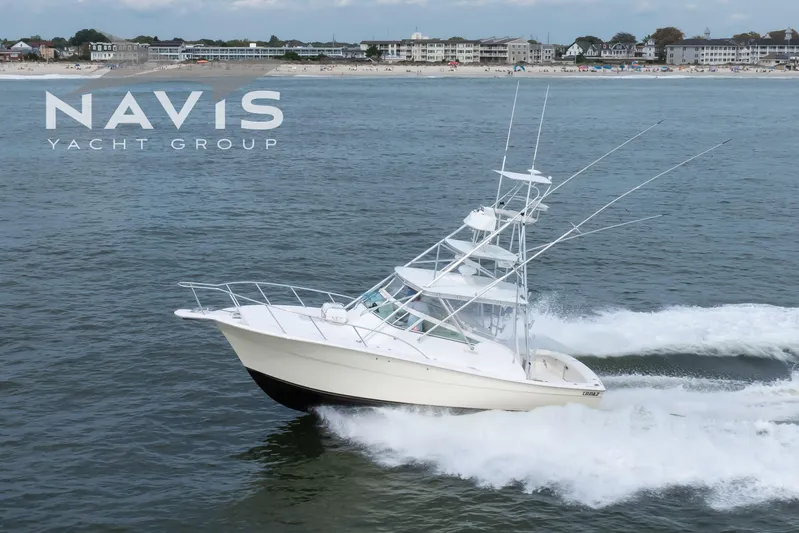 Pipe Dream Yacht Photos Pics 2005 Topaz 32 Express yacht cruising near the shore, Navis Yacht Group branding visible.