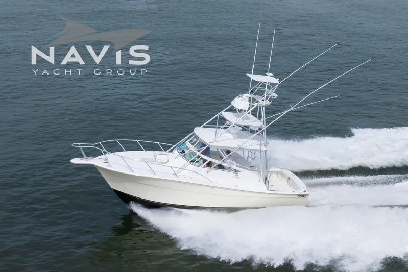 Pipe Dream Yacht Photos Pics 2005 Topaz 32 Express yacht cruising on open water, Navis Yacht Group logo visible.