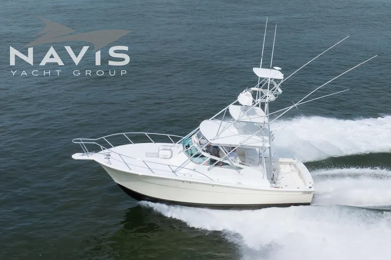 Pipe Dream Yacht Photos Pics 2005 Topaz 32 Express yacht cruising on water, Navis Yacht Group logo visible.