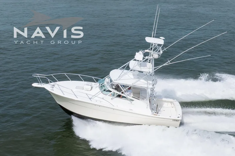 Pipe Dream Yacht Photos Pics 2005 Topaz 32 Express yacht cruising on open water, Navis Yacht Group logo visible.