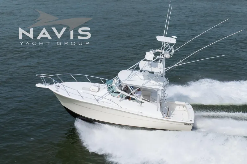 Pipe Dream Yacht Photos Pics 2005 Topaz 32 Express yacht cruising on open water, Navis Yacht Group logo visible.