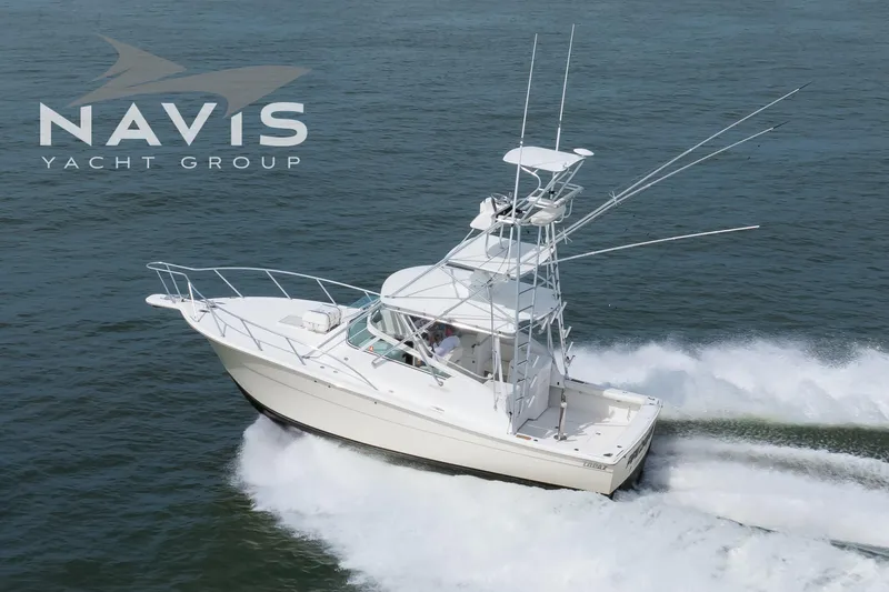 Pipe Dream Yacht Photos Pics 2005 Topaz 32 Express yacht cruising on open water, Navis Yacht Group logo visible.