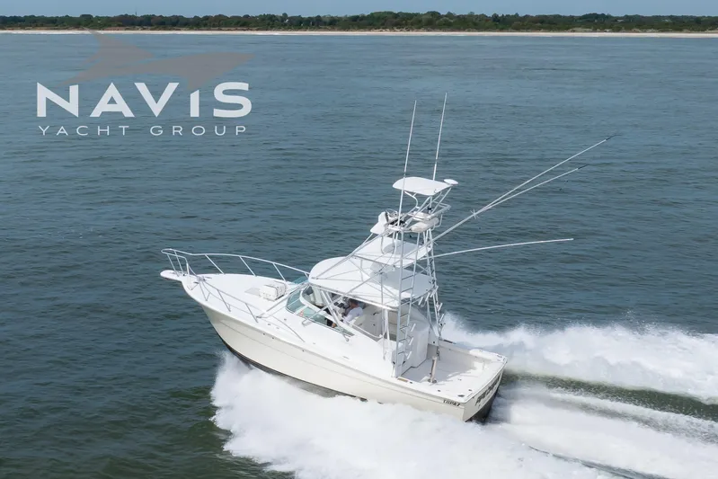 Pipe Dream Yacht Photos Pics 2005 Topaz 32 Express yacht cruising on open water, Navis Yacht Group logo visible.