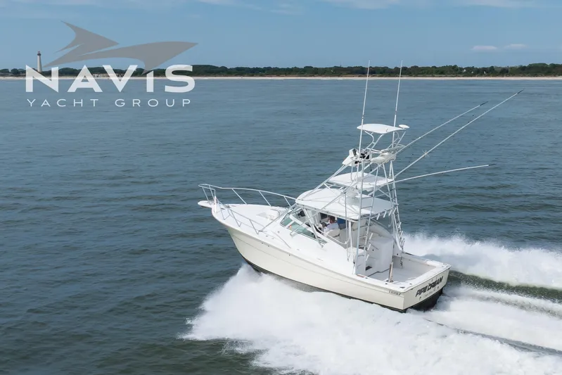 Pipe Dream Yacht Photos Pics 2005 Topaz 32 Express yacht cruising on open water, Navis Yacht Group logo visible.