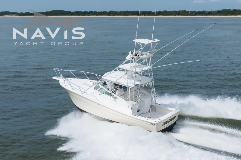 Pipe Dream Yacht Photos Pics 2005 Topaz 32 Express yacht cruising on open water, Navis Yacht Group logo visible.