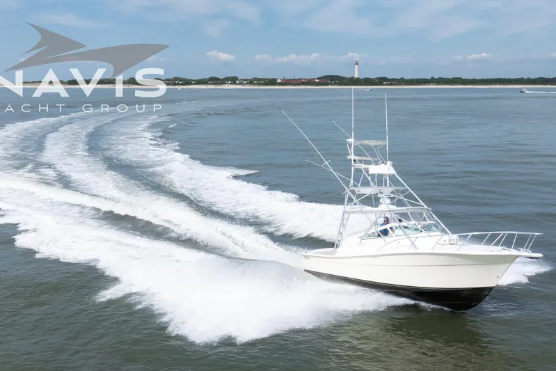 Pipe Dream Yacht Photos Pics 2005 Topaz 32 Express yacht cruising on open water, creating a dynamic wake.