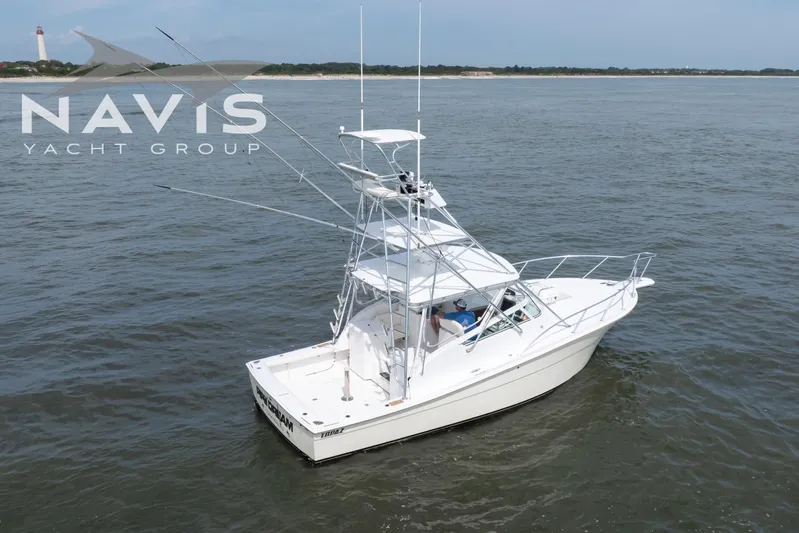 Pipe Dream Yacht Photos Pics 2005 Topaz 32 Express yacht on open water, Navis Yacht Group branding visible.