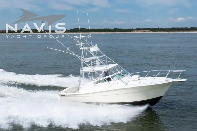 Pipe Dream Yacht Photos Pics 2005 Topaz 32 Express yacht cruising on open water, Navis Yacht Group logo visible.