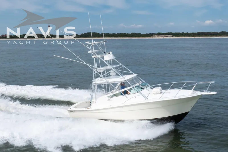 Pipe Dream Yacht Photos Pics 2005 Topaz 32 Express yacht cruising on open water, Navis Yacht Group logo visible.