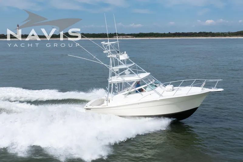 Pipe Dream Yacht Photos Pics 2005 Topaz 32 Express yacht cruising on open water, Navis Yacht Group logo visible.