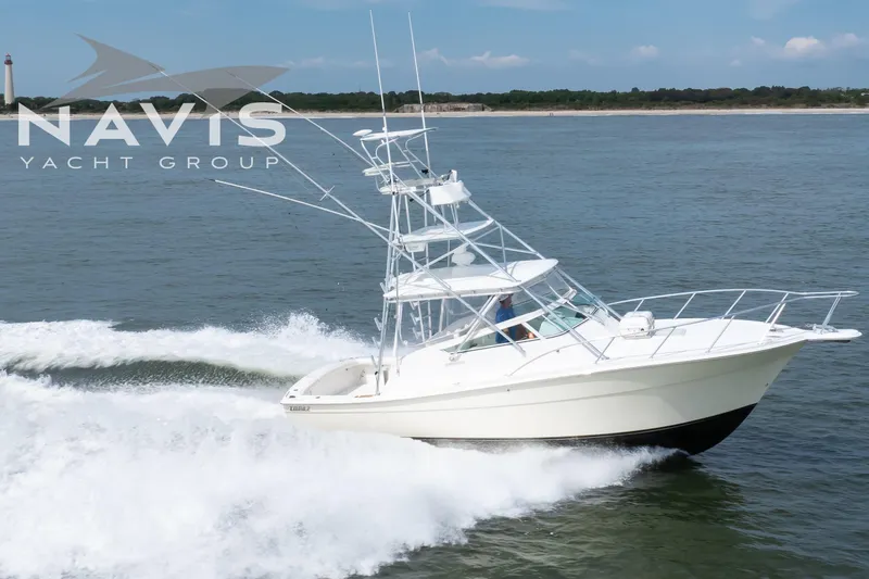 Pipe Dream Yacht Photos Pics 2005 Topaz 32 Express yacht cruising on open water, Navis Yacht Group logo visible.