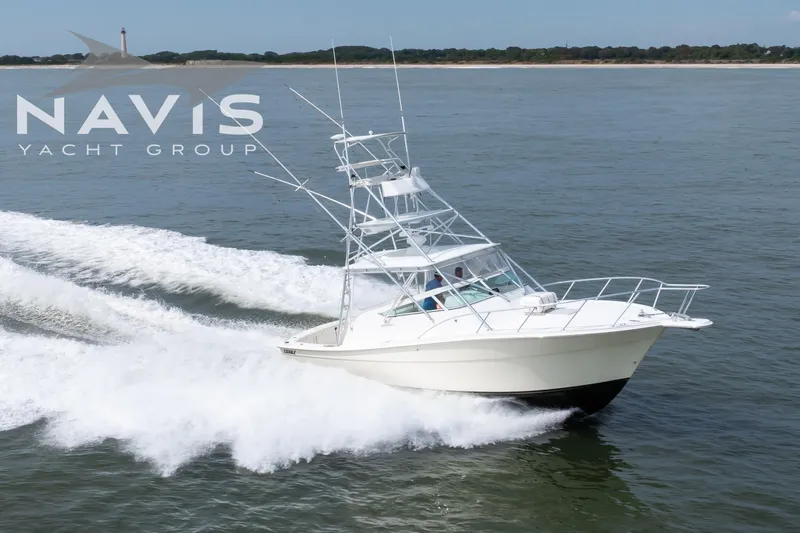 Pipe Dream Yacht Photos Pics 2005 Topaz 32 Express yacht cruising on open water, Navis Yacht Group logo visible.