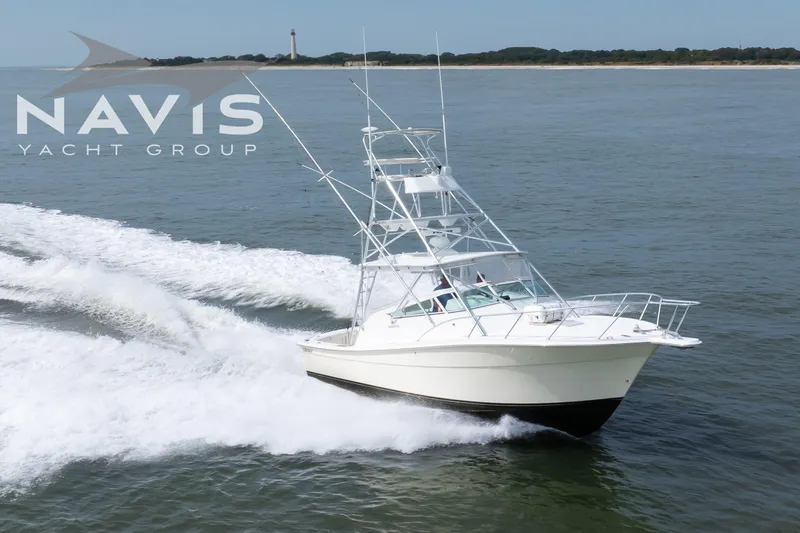 Pipe Dream Yacht Photos Pics 2005 Topaz 32 Express yacht cruising on open water near coastline.