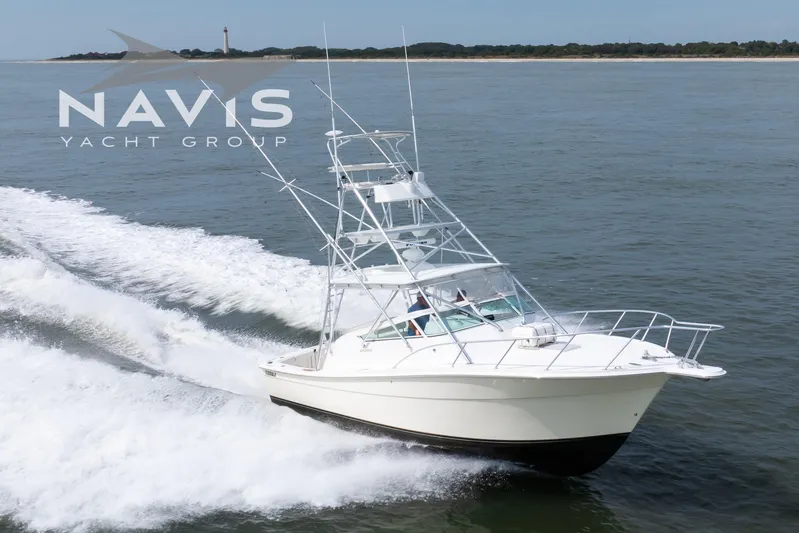 Pipe Dream Yacht Photos Pics 2005 Topaz 32 Express yacht cruising on open water, Navis Yacht Group branding visible.