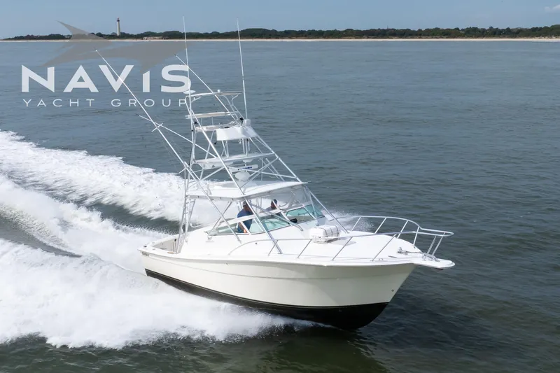 Pipe Dream Yacht Photos Pics 2005 Topaz 32 Express yacht cruising on open water, Navis Yacht Group branding visible.