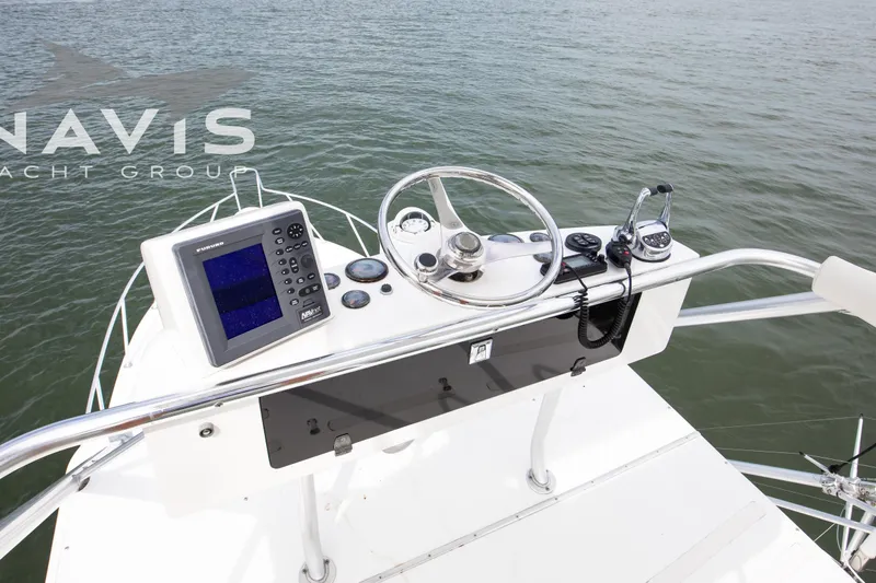 Pipe Dream Yacht Photos Pics Helm of 2005 Topaz 32 Express boat with navigation equipment and steering wheel.