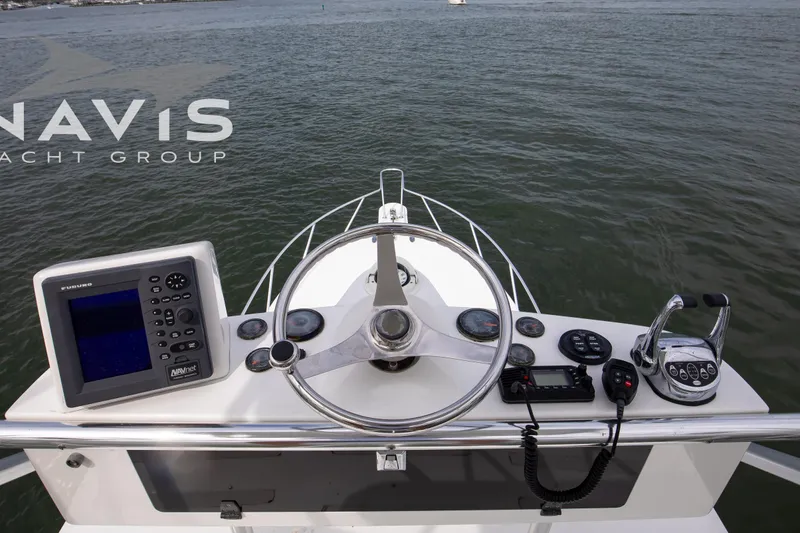 Pipe Dream Yacht Photos Pics Helm of 2005 Topaz 32 Express yacht with navigation equipment and steering wheel.