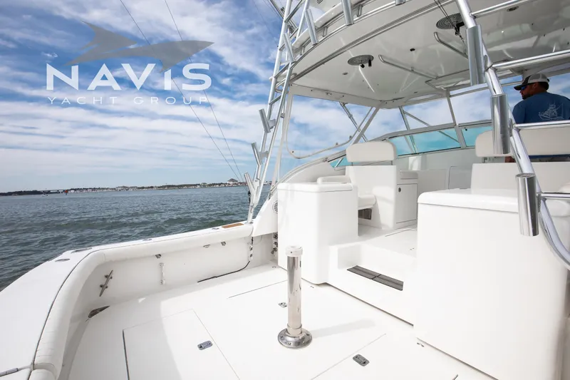 Pipe Dream Yacht Photos Pics 2005 Topaz 32 Express yacht deck with seating, ocean view, and Navis Yacht Group logo.