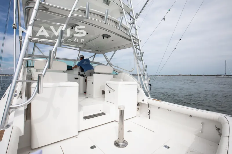 Pipe Dream Yacht Photos Pics 2005 Topaz 32 Express yacht with spacious deck and fishing tower on open water.