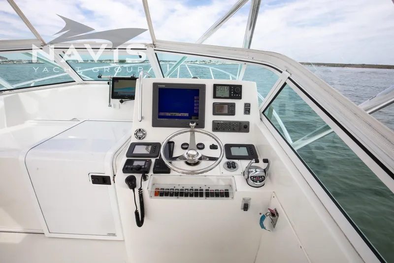 Pipe Dream Yacht Photos Pics Helm of 2005 Topaz 32 Express yacht with navigation equipment and steering wheel.